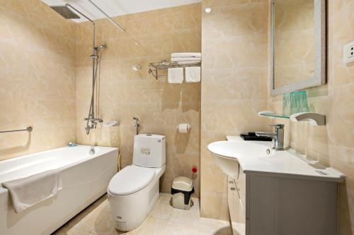 a bathroom with a tub and a toilet and a sink at 22HOUSING 48 Phan Kế Bính in Hanoi