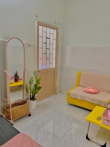 a living room with a couch and a table at Homestay Tuyết Trinh in Nha Trang