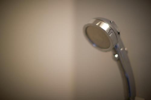 a mirror on the wall of a bathroom at RJ Hotel Naha in Naha
