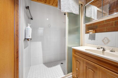 a bathroom with a shower and a sink at INVERLOCH - 2 Separate Houses in one! in Inverloch