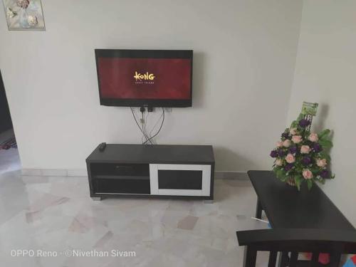 a tv sitting on top of a table in a living room at RLS Home Stay in Kluang