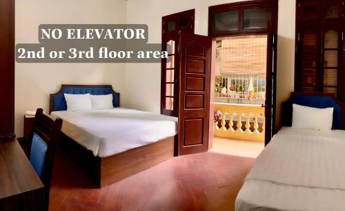 two beds in a room with no elevator and or floor area at Hanoi Hidden Guest House in Hanoi