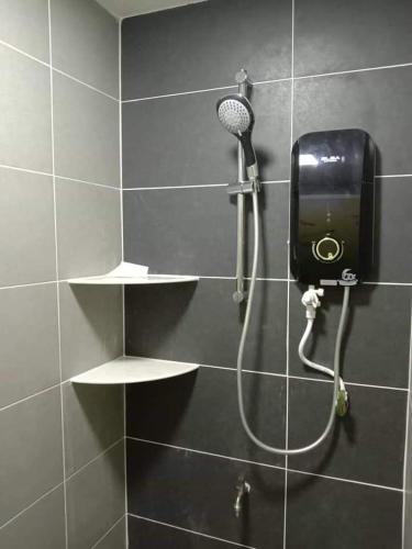 a shower with a blow dryer in a bathroom at RLS Home Stay in Kluang