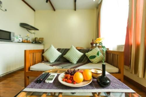 a plate of fruit on a table in a living room at Ambassador Hill in Yangon