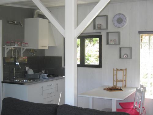 a kitchen with a couch and a table in a room at Casa Do Pinheiral in Ponte da Barca