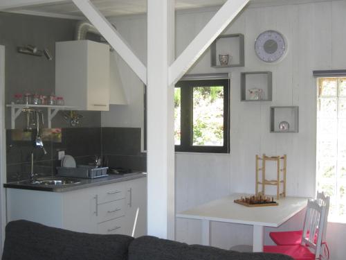 a kitchen with a couch and a table in a room at Cabana do Pinheiral in Ponte da Barca