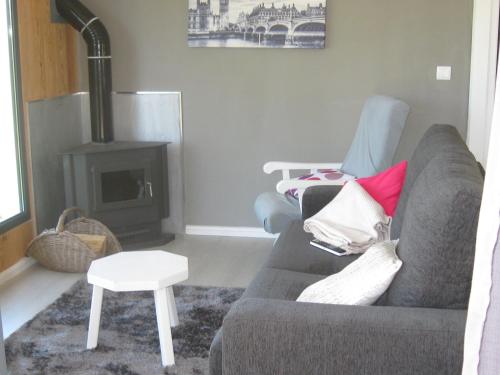 a living room with a couch and a fireplace at Cabana do Pinheiral in Ponte da Barca