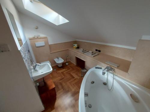a bathroom with a tub and a toilet and a sink at BnB Bagno di Bosco in Gubbio