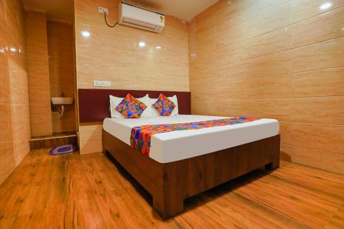 a bedroom with a large bed in a room at FabExpress Arunachala Guest House in Chennai