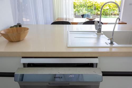 a kitchen with a counter with a sink and a counter at Вилла Vista Del Mare in Koh Samui
