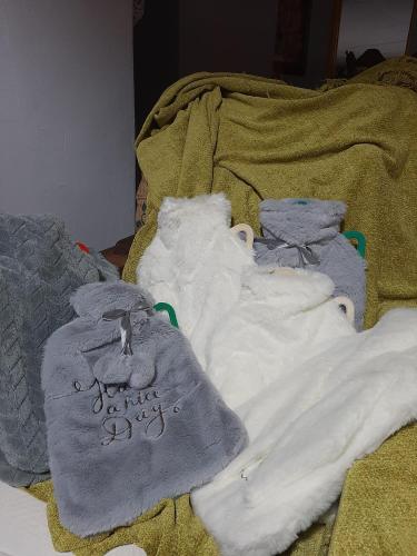 a pile of blankets and towels on a bed at Cesarea Landgoed Guest House in Utrecht