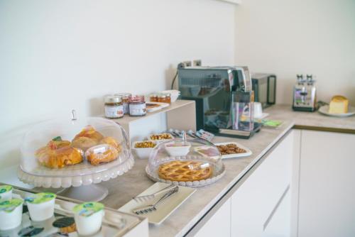 a buffet with various pastries and desserts on a counter at Bedda Mia Etna House B&B in Trecastagni