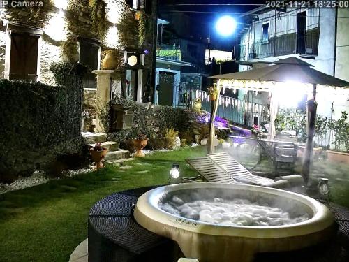 a bath tub in a yard at night at B&B Il Folletto del Lago in Stresa