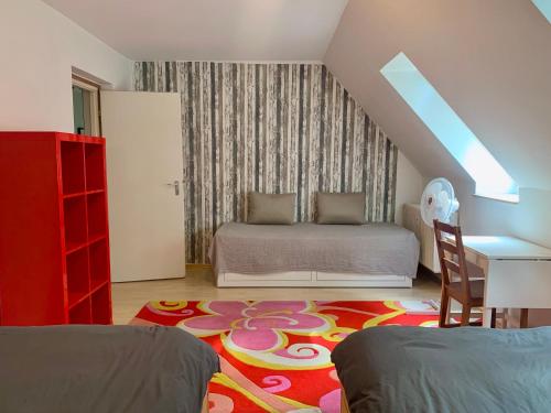 a bedroom with a bed and a table and a desk at Wohnen am Wasserschloss Sandizell in Schrobenhausen