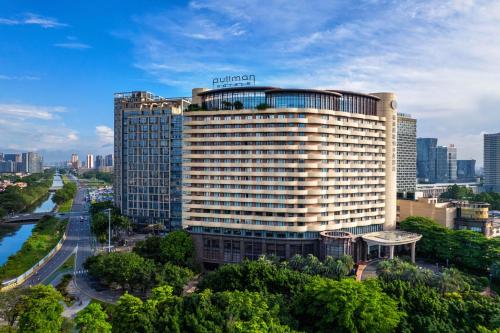 a tall building with a sign on top of it at Pullman Foshan Shunde-Canton Fair Shuttle Bus at Extra RMB100 Daily in Shunde