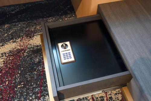 a remote control sitting on top of a wooden box at Hotel JAL City Nagoya Nishiki in Nagoya