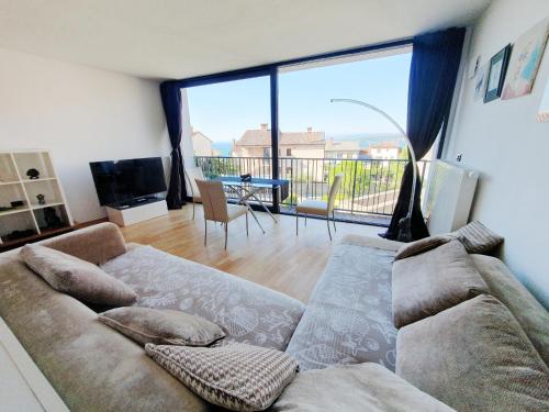 a living room with a couch and a large window at Bella Vista Lux Apartment with private Terace in Koper
