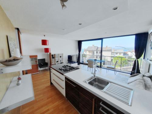 a kitchen with a sink and a large window at Bella Vista Lux Apartment with private Terace in Koper