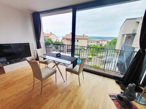 a dining room with a table and chairs and a large window at Bella Vista Lux Apartment with private Terace in Koper