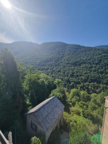 an old building in the middle of a forest of trees at Auberge du Crabère in Melles