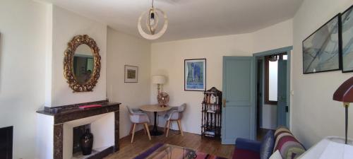 a living room with a fireplace and a mirror at The Apartments, Rue Barbès in Carcassonne