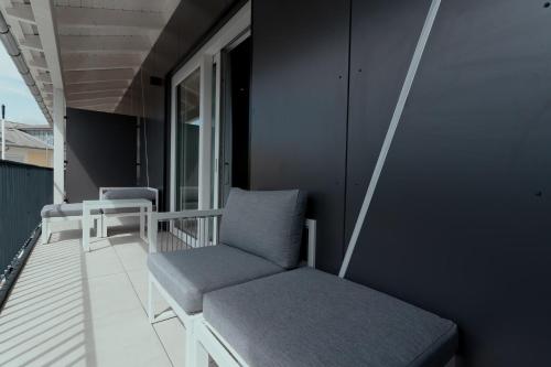 a balcony with a chair and a window at Hotel Andante Rust in Rust