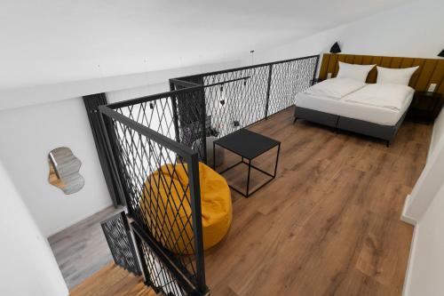 a balcony with a bed and a couch at Hotel Andante Rust in Rust