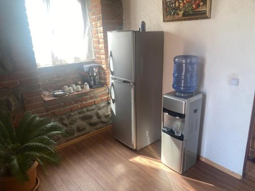 a refrigerator and a water cooler in a room at Old House in Lagodekhi