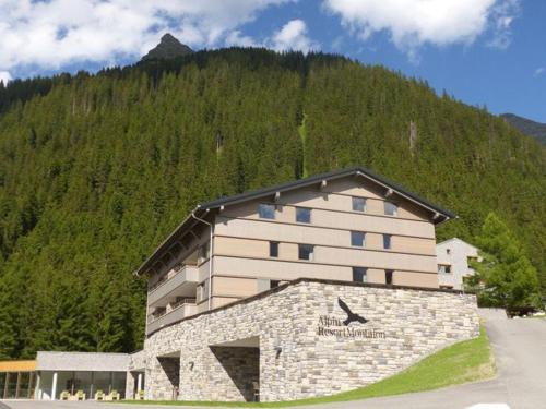 a large building in front of a mountain at Apartment Typ D im Alpin Resort Mo in Gargellen