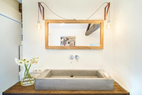 a bathroom with a large sink and a mirror at B&B Le Rêve Maastricht in Maastricht