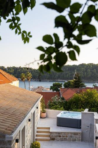 a view of a house with a hot tub on a patio at Holiday Home Nico's in Cavtat