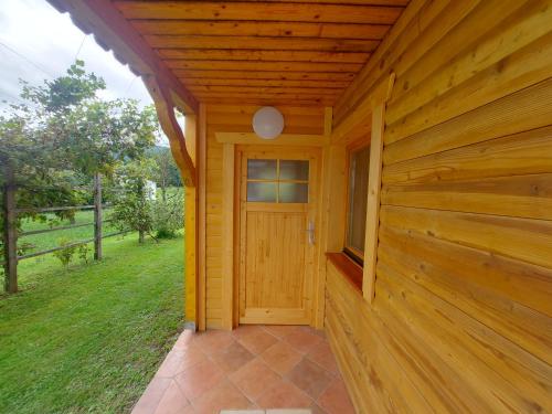 a wooden cabin with a door and a porch at Apartma Markelj in Radovljica