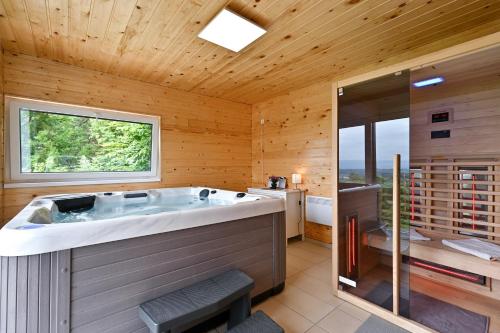 a large bathroom with a large tub and a window at Kuća za odmor Freya in Krapinske Toplice