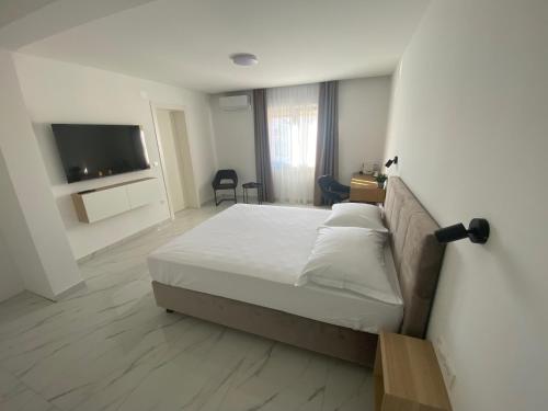 a bedroom with a bed and a flat screen tv at Guest House Ana Residence in Zadar