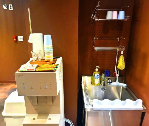 a kitchen with a sink and a mixer next to a counter at Good Guesthouse in Seoul