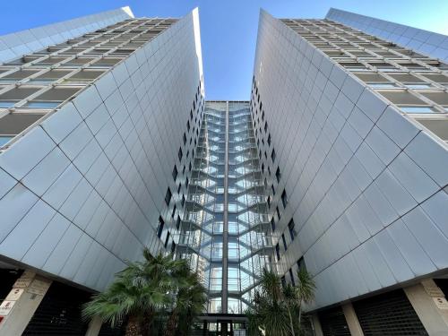 two tall buildings with palm trees in front of them at Redi Home in Bari