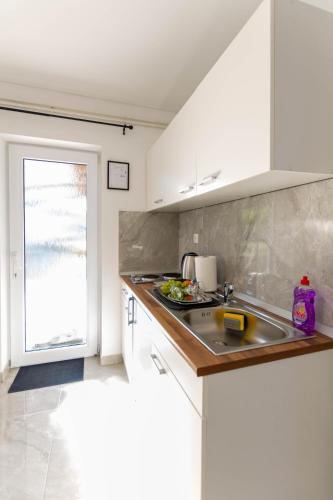 a kitchen with a sink and a counter top at apartmani SUN & MOON in Bjelovar