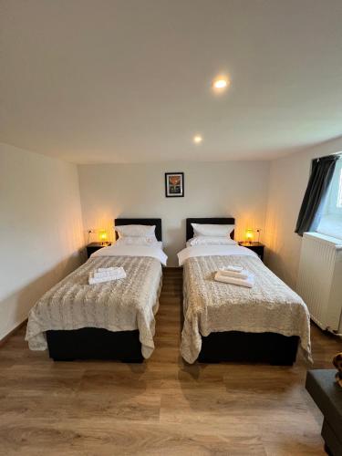 a bedroom with two beds in a room at Aparts4ring Nürburg in Nürburg