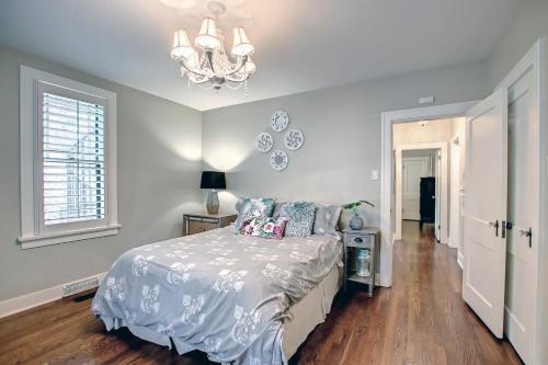 a bedroom with a bed and a chandelier at Stunning Historical Landmark in Elbow Park in Calgary