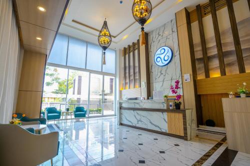 a lobby with a reception desk in a building at HT9 Hotel in Jomtien Beach