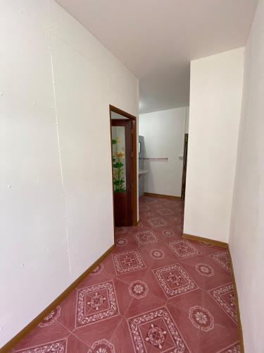 an empty room with a red tile floor and white walls at ศรีวดีโฮม(Sriwadee Home) in Ban Phai