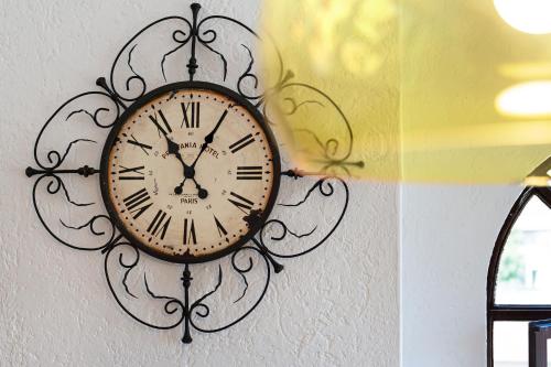 a clock is hanging on a wall at Mansarda Vialba in Germignaga