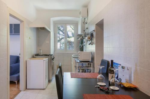 a kitchen with a counter and a refrigerator in a room at Vista&C 2 in Trieste
