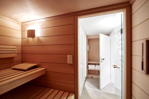 a sauna with wood paneling and a glass door at Freywind in Norderney