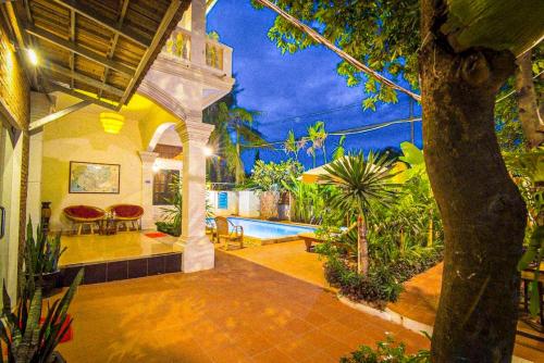 a painting of a house with a swimming pool at Ravoeun Angkor Boutique in Siem Reap