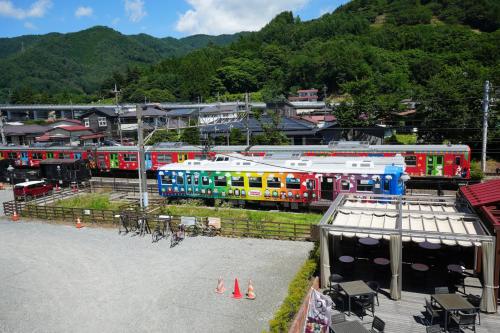 a group of trains parked next to a train station at お宿 櫻川　Oyado Sakuragawa in Fujiyoshida