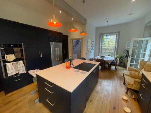 a kitchen with a island in the middle of a room at Large 3 double bedroom period house with parking in Edinburgh