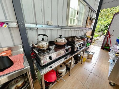 a kitchen with two pots and pans on a stove at Baluo Baluo in Sun Moon Lake