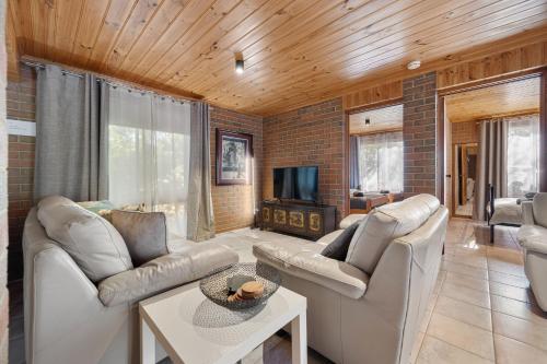 a living room with two couches and a tv at Affordable GEM in the heart of Inverloch in Inverloch