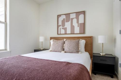 a bedroom with a large bed and two lamps at Somerville 1br w wd gym roof nr Assembly T BOS-840 in Somerville